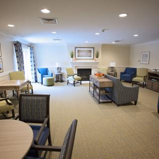 A well-furnished living room with multiple seating arrangements and a fireplace.