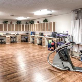 A spacious fitness area equipped with various exercise machines, designed for rehabilitation and health improvement.