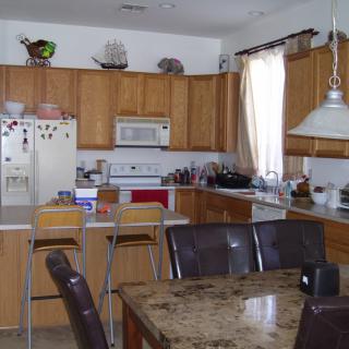 A cozy kitchen and dining area with wooden cabinets and modern appliances.