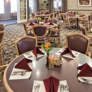 Elegantly set dining area with neatly arranged tables and chairs.