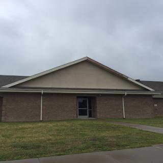 A view of a modern building under a cloudy sky.