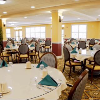 An elegant dining room with neatly arranged tables and chairs.