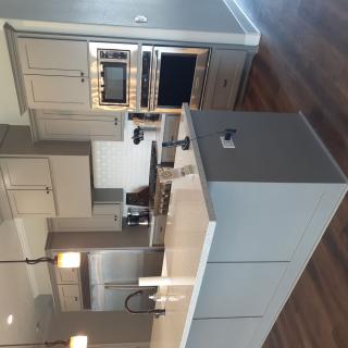 A modern kitchen with a central island and stainless steel appliances.