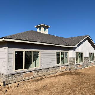 A newly constructed house featuring modern architectural design and ample windows.