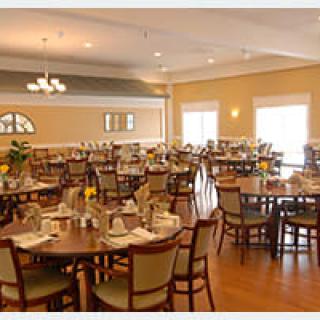 A cozy dining room with neatly arranged tables and chairs.