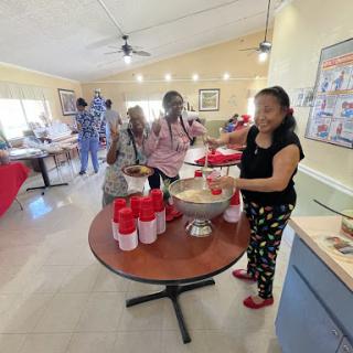 A lively community gathering where people are enjoying food and socializing.