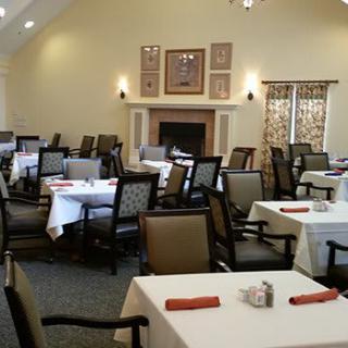A well-arranged dining room with multiple tables and chairs, ready for guests.