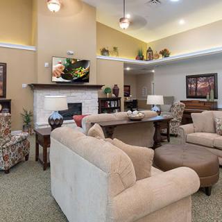 A cozy living room with comfortable seating and a fireplace.