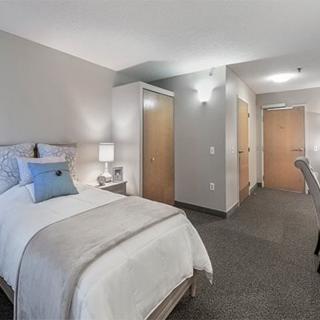 A modern, minimalist bedroom with neutral tones and simple decor.