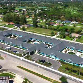 Aerial view of a residential complex surrounded by greenery.