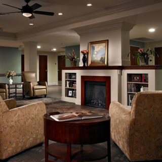 A cozy living room with a fireplace and comfortable seating.