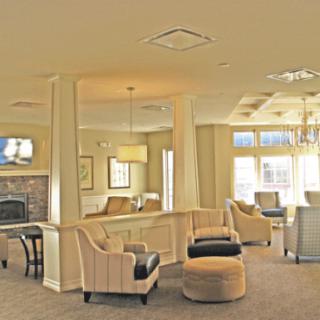 A cozy lobby with comfortable seating, a fireplace, and elegant lighting.