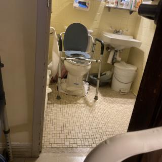 An accessible bathroom equipped with a toilet and sink.