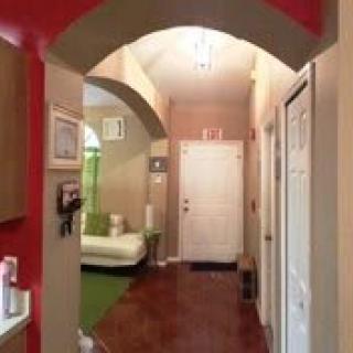 A cozy hallway with an archway and stylish decor.