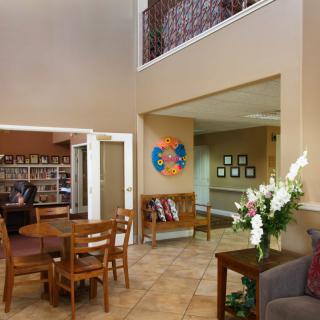 A cozy lobby area with seating, a table, and decorative elements.