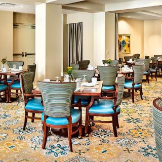 A well-decorated restaurant dining area with neatly arranged tables and chairs.