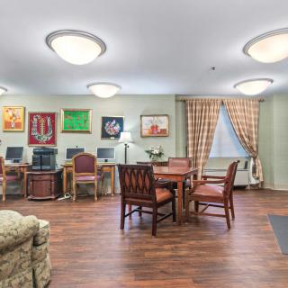 A cozy lounge area with computers, tables, and comfortable seating.