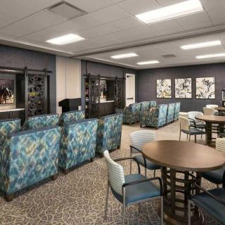 A modern lounge area with patterned seating and tables.