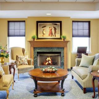 A cozy living room with a fireplace, elegant furniture, and tasteful decor.