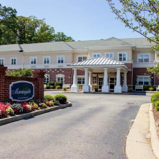 A well-maintained building with a welcoming entrance and landscaped surroundings.