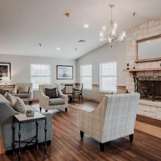 A cozy and inviting living room featuring comfortable seating and a warm fireplace.
