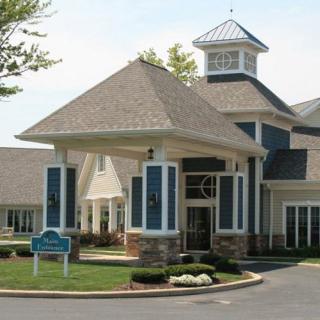 A well-maintained entrance of a retirement home with attractive landscaping.