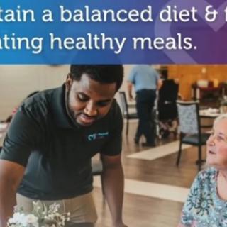 A person assisting an elderly woman with meal choices to promote a balanced diet and healthy eating.