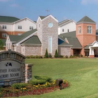 A well-maintained church building surrounded by green lawns and landscaping.