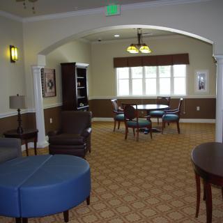 A cozy lounge area with comfortable seating and a table near the window.