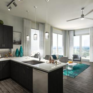 A modern open-plan kitchen and living area with large windows and ample natural light.