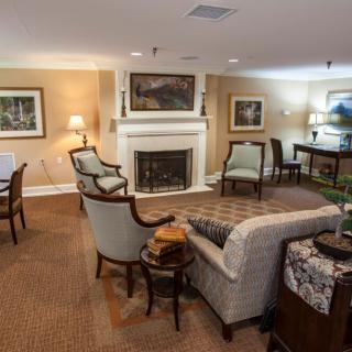 A cozy living room featuring a fireplace, comfortable seating, and elegant decor.