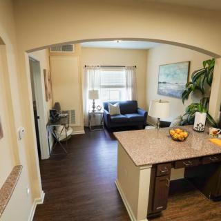 A cozy apartment with an open-plan living room and kitchen area.