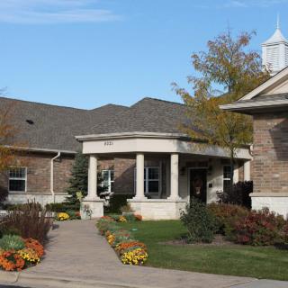 A building with a landscaped garden and an entrance walkway.