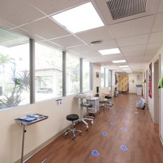 A modern clinic hallway featuring clean lines and ample natural light.