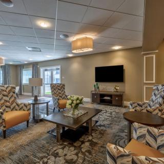 A modern living room with comfortable seating and a flat-screen TV.