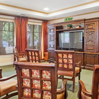 A cozy living room with wooden furniture and a large TV, offering a warm and inviting space.