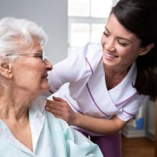 A nurse providing care and support to a senior woman.