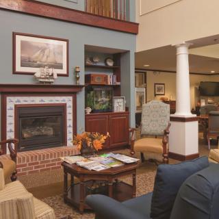 A cozy living room with a fireplace and comfortable seating.