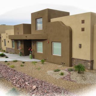 A modern desert home featuring adobe-style architecture.
