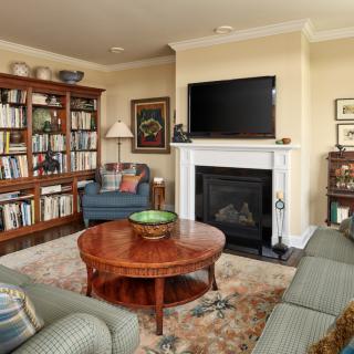 Cozy living room with a bookshelf and fireplace.