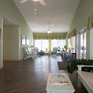 A bright and inviting living room with ample natural light, comfortable seating, and a peaceful ambiance.