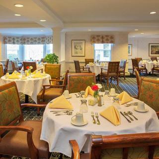 An elegant dining room with neatly arranged tables and chairs, ready for guests.