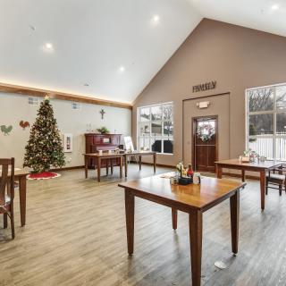 A cozy dining area decorated for the holidays with a Christmas tree and festive accents.