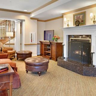 A cozy living room with a fireplace and comfortable seating.