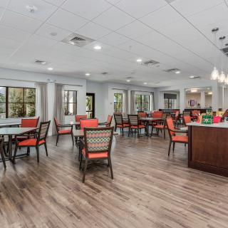 A spacious dining area with modern furnishings and ample natural lighting.