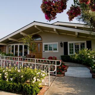 A charming bungalow with a well-maintained garden and inviting front porch.