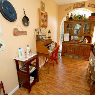 A cozy kitchen with vintage decor and wooden furniture.