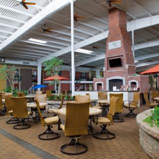 A cozy indoor dining area featuring a large fireplace, perfect for casual gatherings.