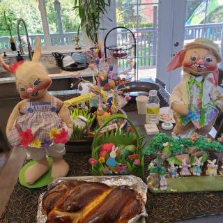 Festive Easter decorations with bunnies and baked bread in a kitchen setting.