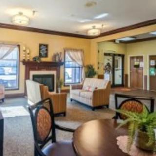 A cozy living room interior with sofas, a fireplace, and elegant decor.